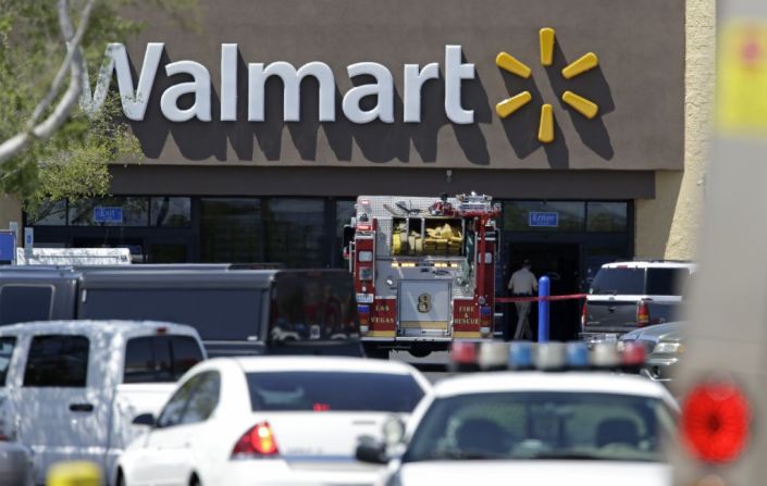 Police and firefighters on the scene of the shooting at a Las Vegas Walmart, on Sunday, June 8. Two gunmen shot and killed two police officers eating lunch and then killed a third person at the Walmart. The gunmen then killed themselves. 