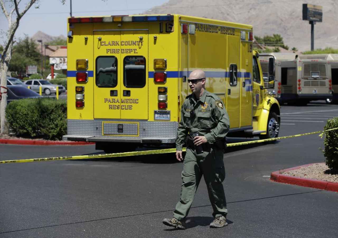 A Las Vegas Metropolitan Police officer monitors the scene.