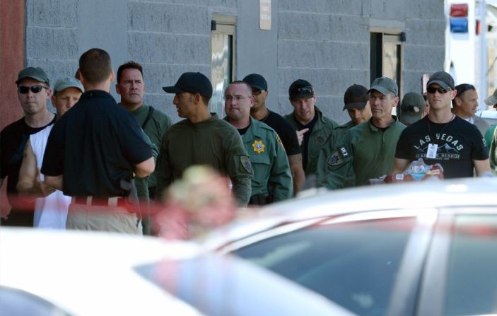 Las Vegas Metropolitan Police Department personnel gather outside the Walmart where one person was shot and killed.