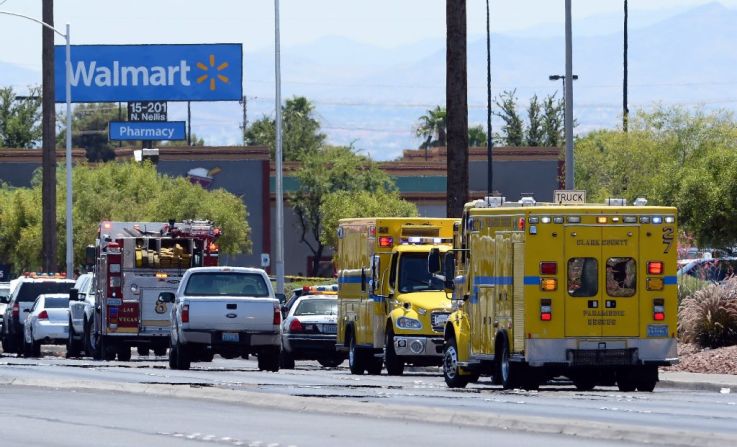 Police and fire vehicles line the street near the scene.