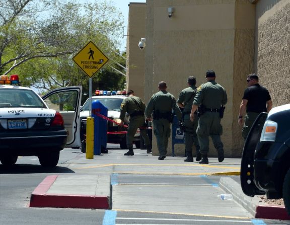 Police officers move to enter the Walmart.