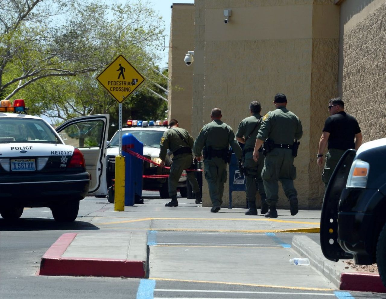 Police officers move to enter the Walmart. 