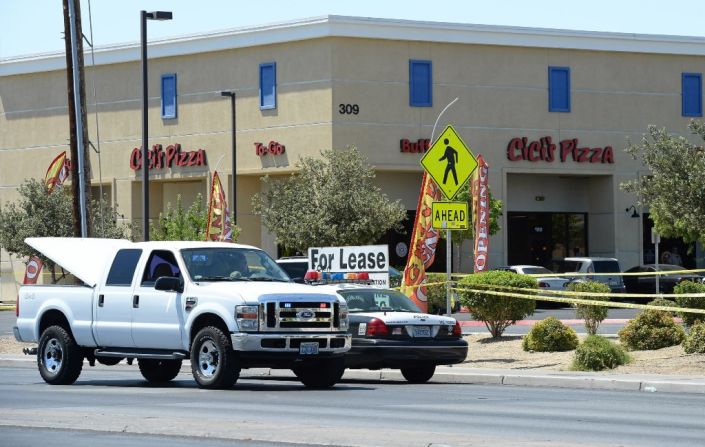 Las Vegas Metropolitan Police Department vehicles are parked outside a Las Vegas Cici's Pizza restaurant. Two police officers were shot while they were having lunch Sunday.