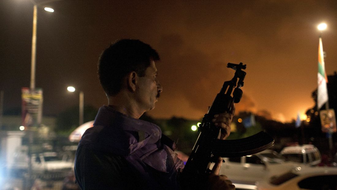 A Pakistani soldier holds his weapon ready at the airport Sunday, June 8. A building caught fire in the attack, but no planes were damaged, a military spokesman said.