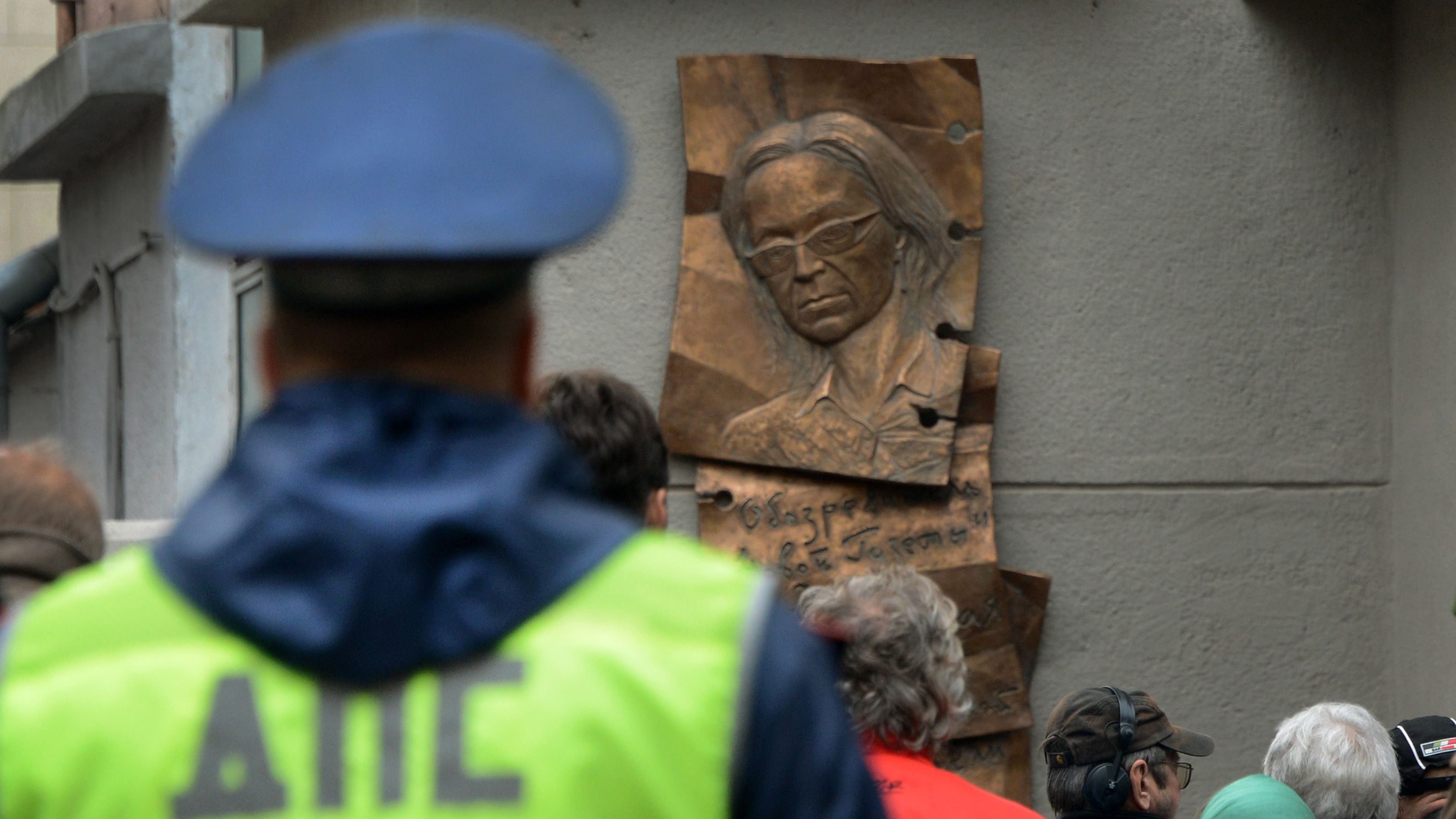 People look at a plaque commemorating slain reporter Anna Politkovskaya in Moscow.
