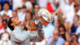 Rafael Nadal of Spain celebrates with the Coupe de Mousquetaires after victory in his men's singles final match against Novak Djokovic of Serbia on day fifteen of the French Open at Roland Garros on June 8, 2014 in Paris, France.