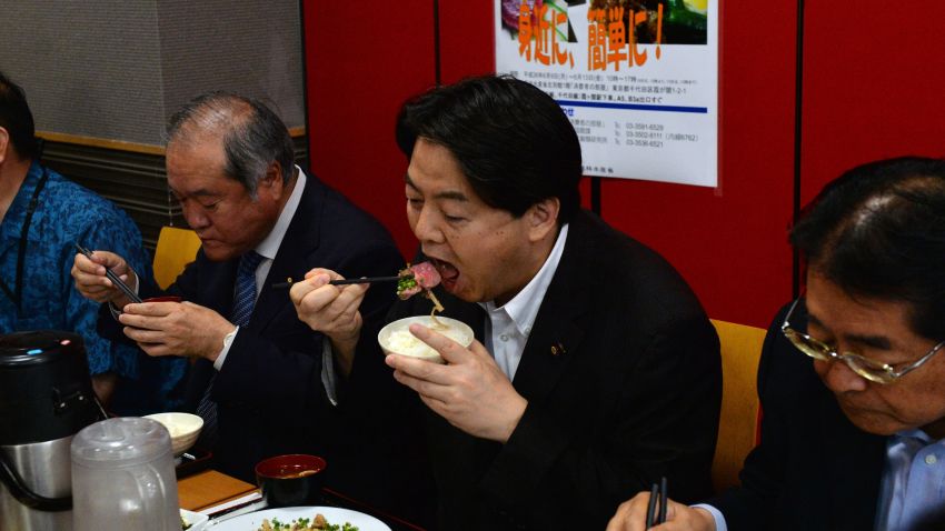 Japanese Agriculture Minister Yoshimasa Hayashi (2nd R), accompanied by Japanese lawmakers, eats whale meat for the promotion of to eat whale meat at his ministry in Tokyo on June 9, 2014. Japan's prime minister told parliament he would boost his efforts toward restarting commercial whaling, despite a top UN court's order that Tokyo must stop killing whales in the Antarctic.