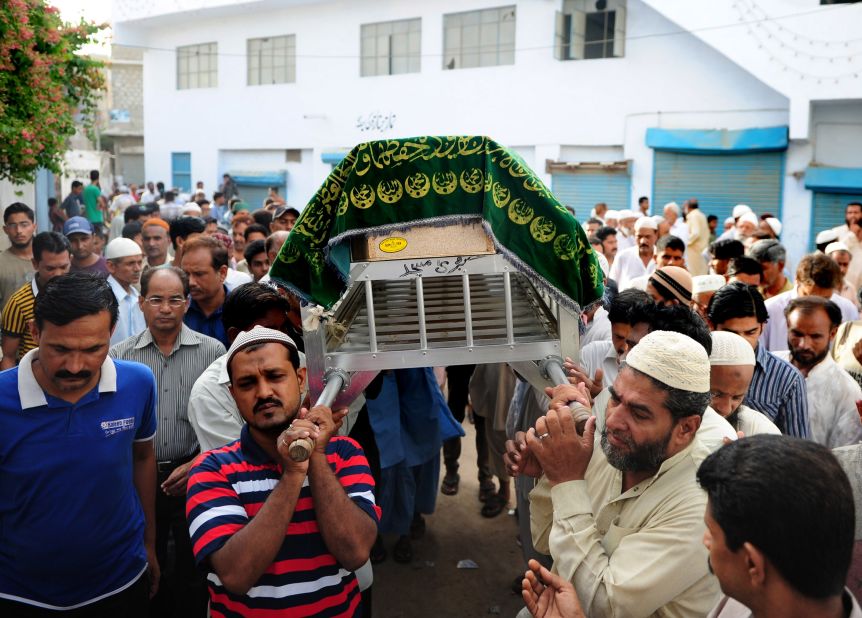 Mourners arrive for funeral prayers on June 10 in Karachi.