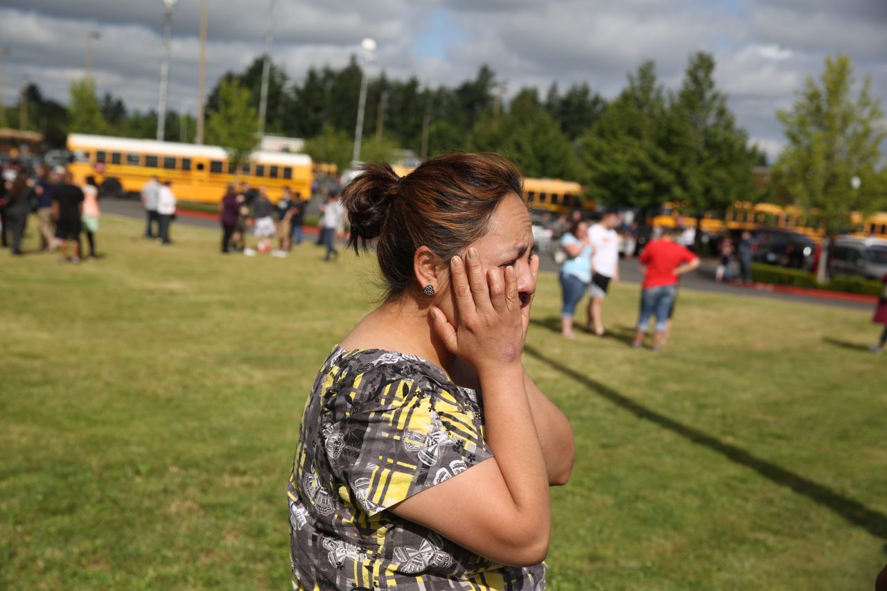 A distraught woman waits for news after the school shooting June 10.