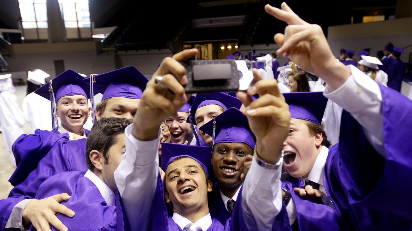 Classmates from Deering High School take a photo together prior to graduation Thursday, June 5, in Portland, Maine.