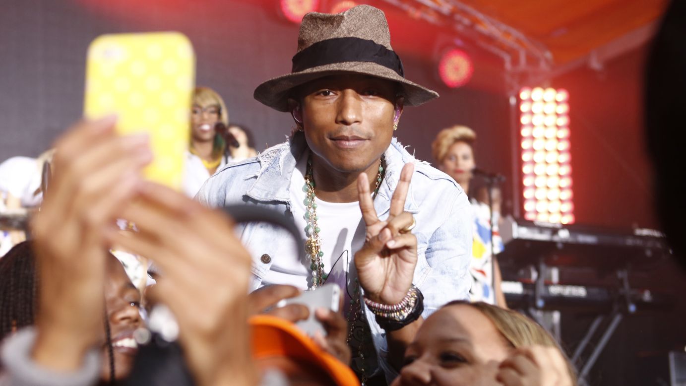 Musician Pharrell Williams flashes the peace sign for a photo taken Thursday, June 5, during an appearance on NBC's "Today" show.
