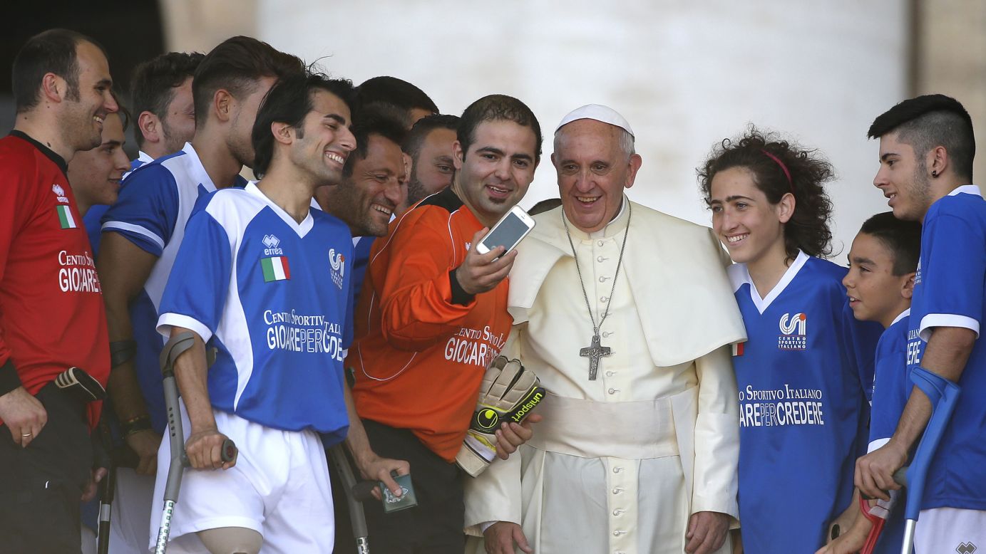 Pope Francis appears in a selfie with members of Italy's amputee soccer team Saturday, June 7, at the Vatican.