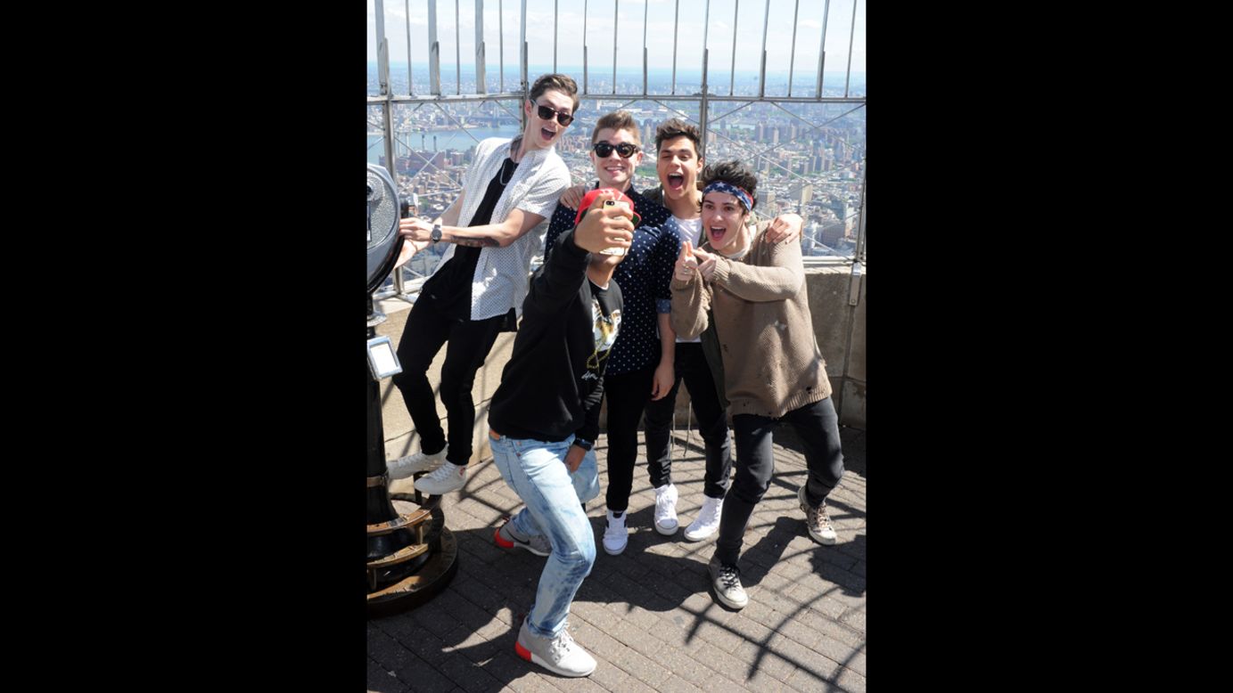 The boy band Midnight Red takes a photo during a visit to the Empire State Building in New York on Thursday, June 5.