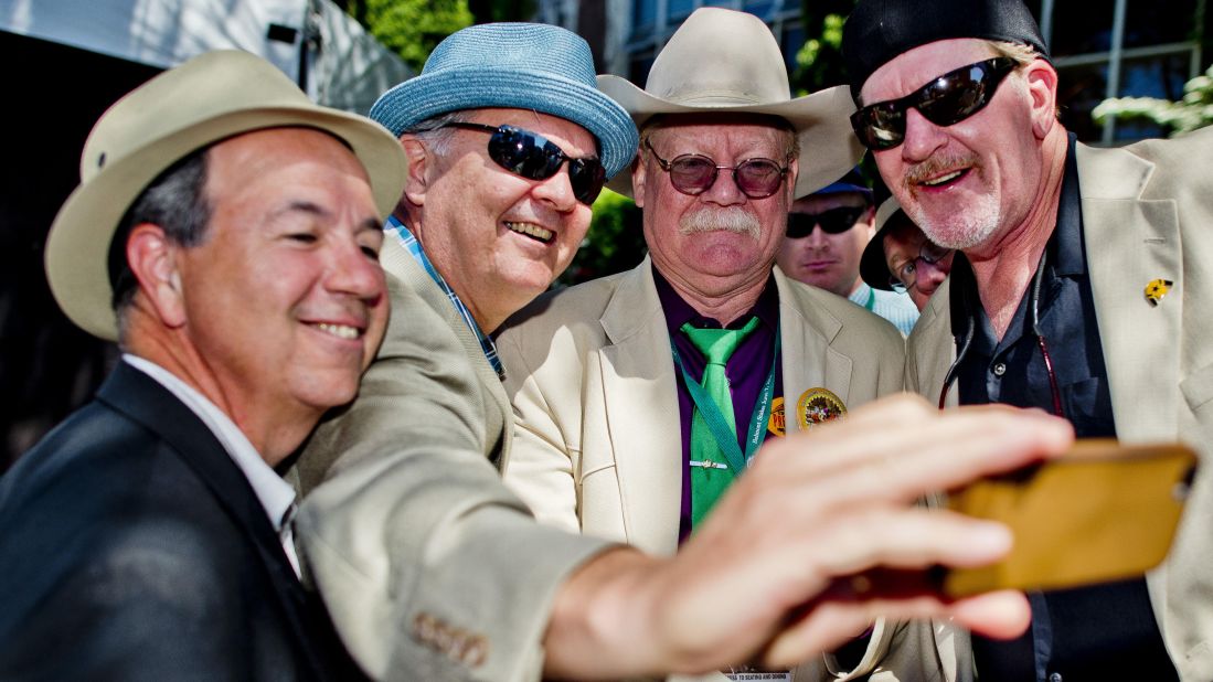 California Chrome co-owner Steve Coburn (second from right) poses for a photo with fans prior to the Belmont Stakes in June -- the final leg of the Triple Crown.