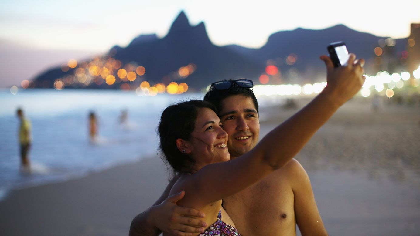 A couple snaps a selfie Sunday, June 8, on Ipanema Beach in Rio de Janeiro. Rio is one of the 12 Brazilian cities that will be hosting World Cup soccer games this month.