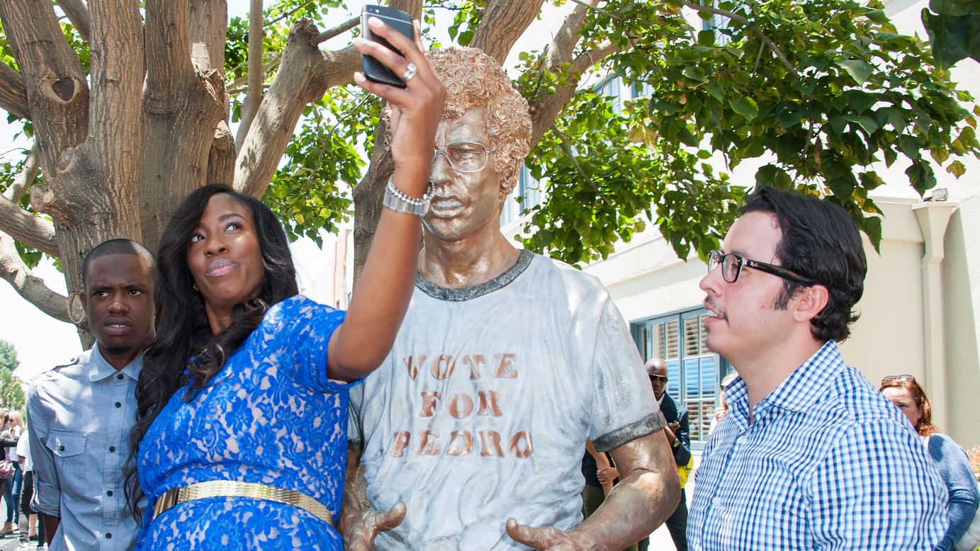 Actors Shondrella Avery and Efren Ramirez, who both appeared in "Napoleon Dynamite," stand next to a statue of the film's main character Monday, June 9, in Century City, California. Fox Searchlight Pictures and 20th Century Fox Home Entertainment were celebrating the movie's 10th anniversary.