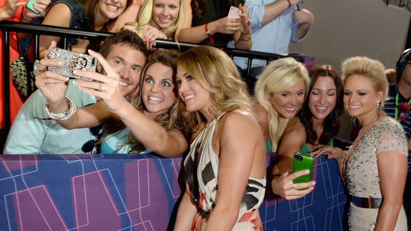 Country music stars Miranda Lambert, right, and Carrie Underwood take photos with fans Wednesday, June 4, at the CMT Music Awards in Nashville, Tennessee.
