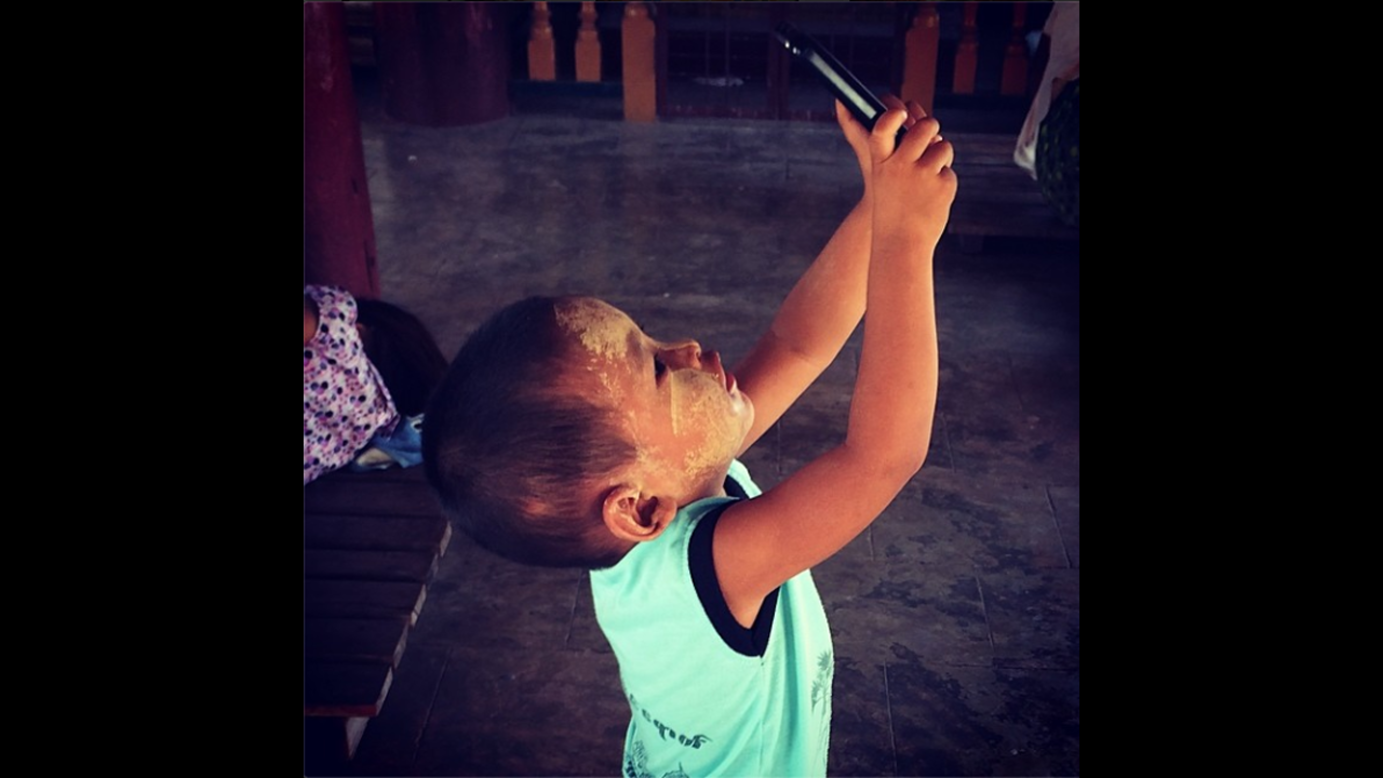 CNN producer Mitra Mobasherat <a href="http://instagram.com/p/o5DCH9sHkh/" target="_blank" target="_blank">snapped this photo</a> of a young boy taking a selfie Friday, June 6, while his mother and grandmother prayed at a Buddhist temple in Bagan, Myanmar.