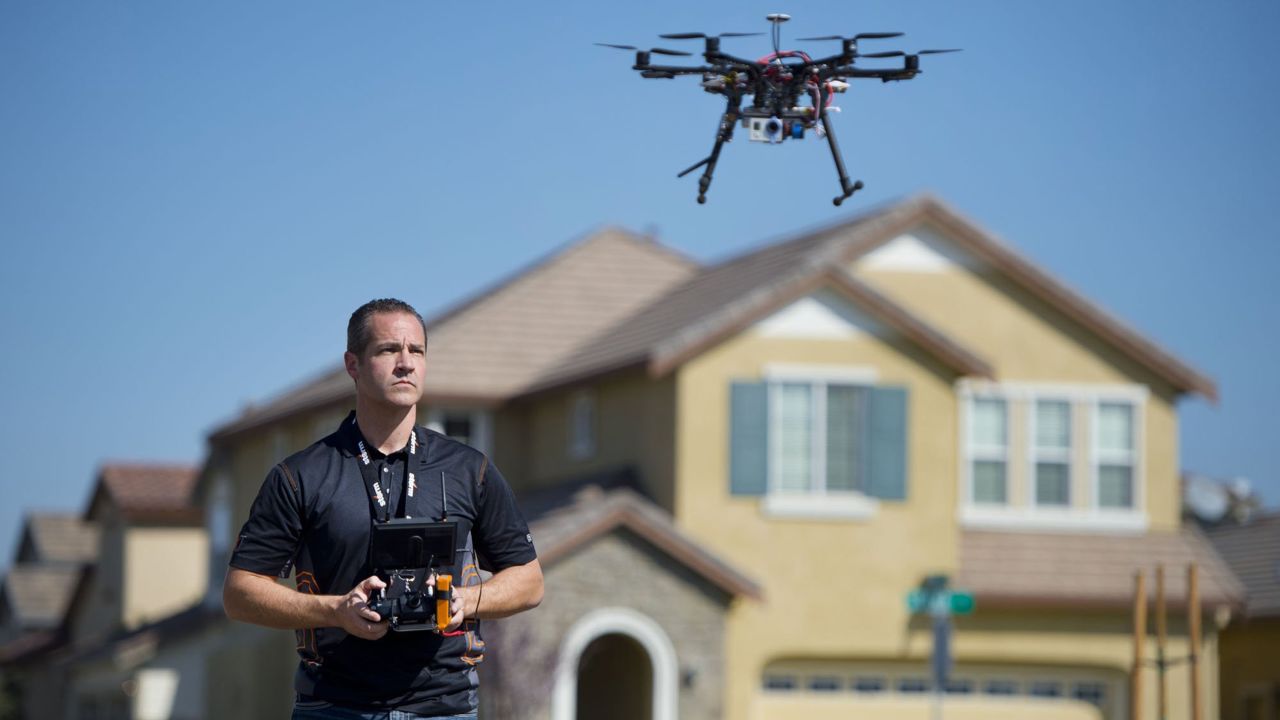 Christopher Brown of the Next New Homes Group uses a drone to take aerial video of a home in Sacramento, California, on February 25, 2014. Drones are increasingly being used by small companies to shoot promotional videos.