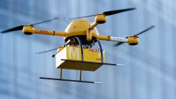 BONN, GERMANY - DECEMBER 09:  A quadcopter drone arrives with a small delivery at Deutsche Post headquarters on December 9, 2013 in Bonn, Germany. Deutsche Post is testing deliveries of medicine from a pharmacy in Bonn in an examination into the viability of using drones for deliveries of small packages over short distances. U.S. online retailer Amazon has also started its intention to explore the possibilities of using drones for deliveries.  (Photo by Andreas Rentz/Getty Images)