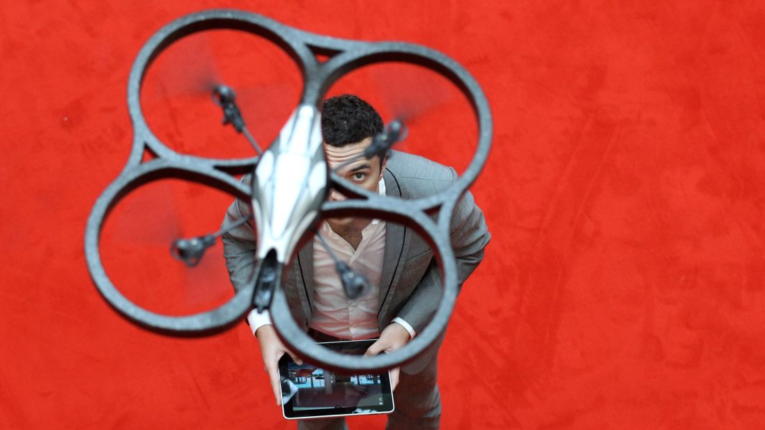 A man controls an Parrot AR Drone with an iPad during the press preview day of the International Toy Fair in Nuernberg, Germany, on February 2, 2011.