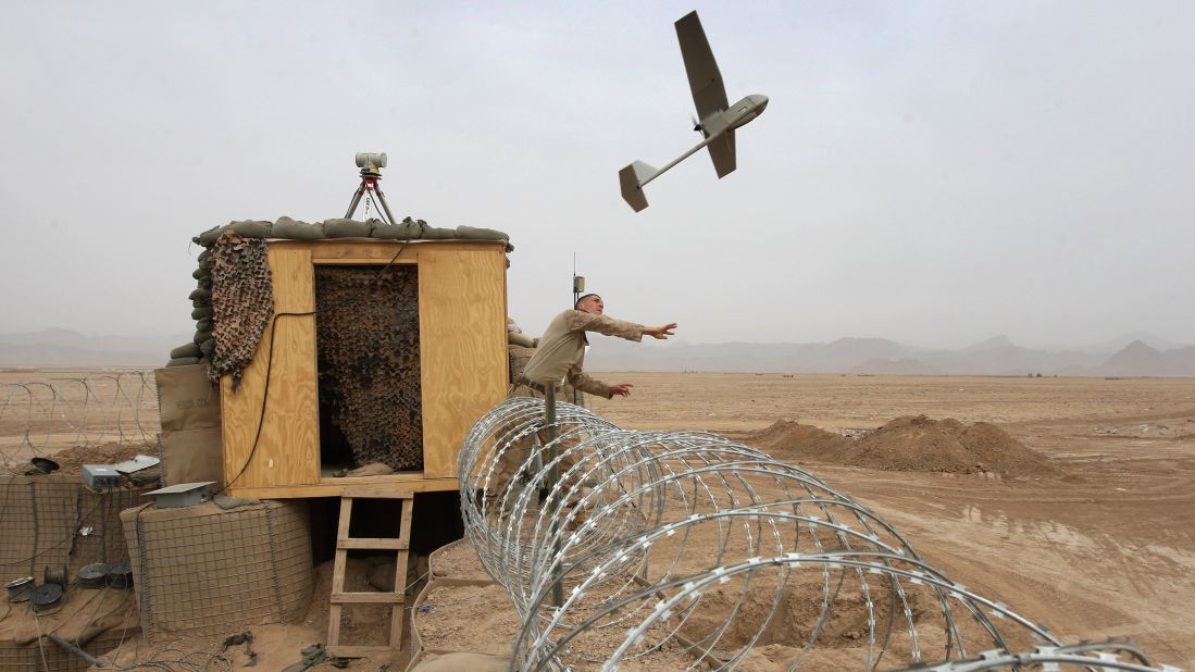 U.S. Marine Sgt. Nicholas Bender launches a Raven surveillance drone from Marine base near the remote village of Baqwa, Afghanistan, on March 21, 2009. Marines use the unmanned aerial vehicles to get real-time intelligence on Taliban movements.