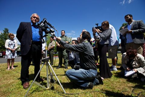 Troutdale Mayor Doug Daoust addresses reporters at a June 10 press conference in a Safeway parking lot near the school.