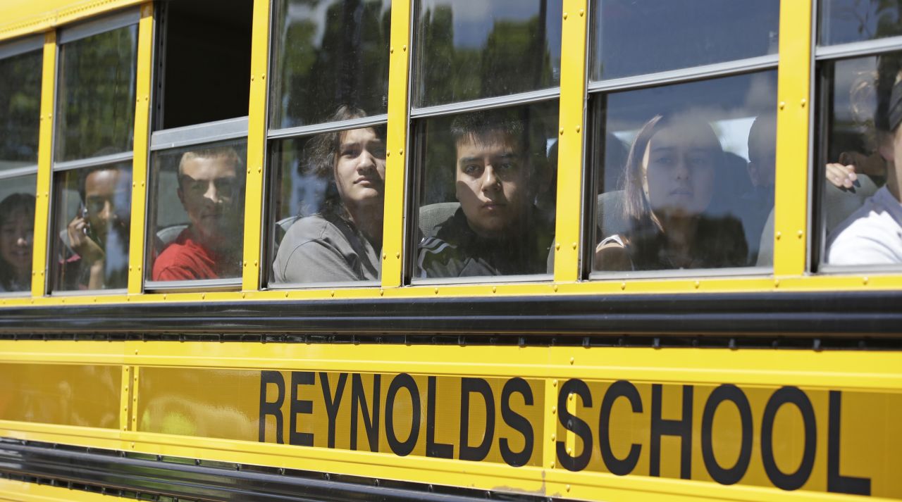 Students look for family members after arriving at a shopping center parking lot June 10 in Wood Village, Oregon, after the shooting in nearby Troutdale.