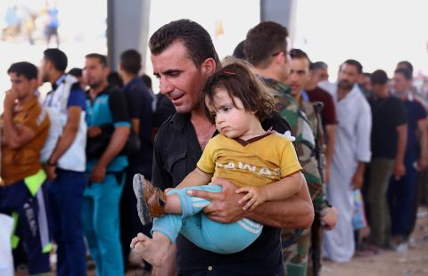Refugees are seen in Erbil on June 10.