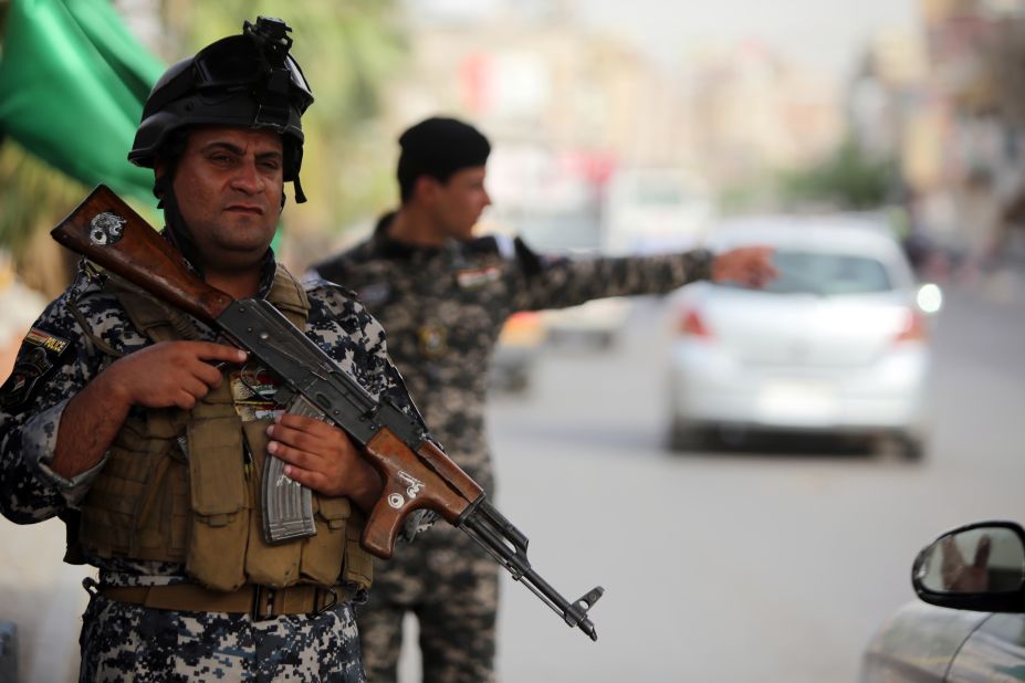 Iraqi police stand guard at a checkpoint in Baghdad. 