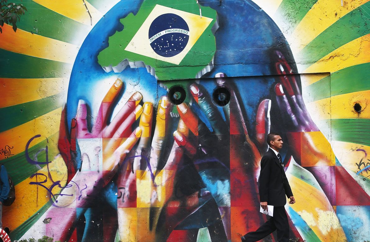 In this attention-grabbing image a collection of multi-colored hands support the planet marked with a Brazilian flag, welcoming visitors from across the world to South America's largest nation.