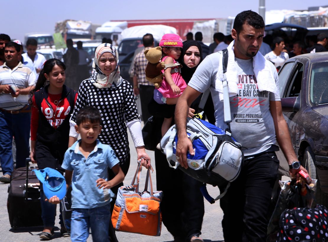 Iraqi families flee Nineveh province after ISIS took control in 2014.