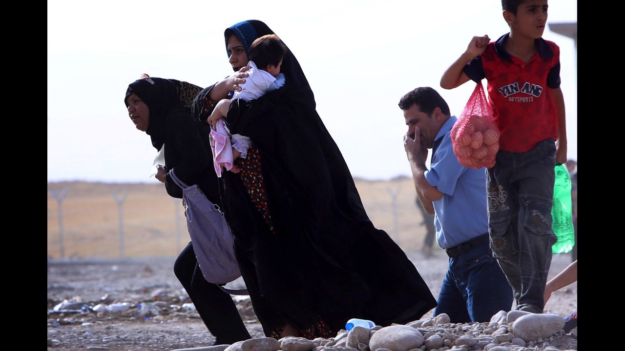 Families gather at a checkpoint in Iraq's Kurdish region on June 11.