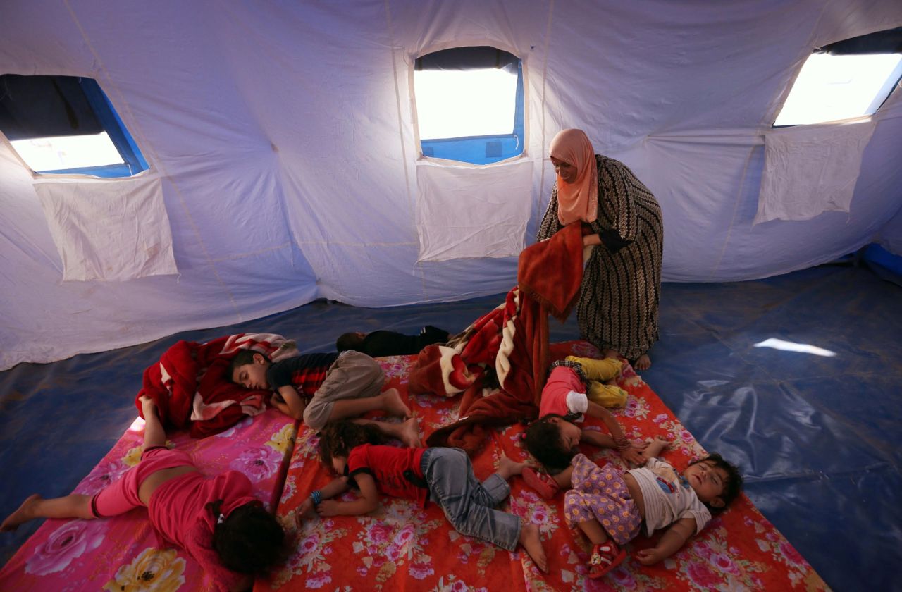 Young refugees sleep in a tent at a temporary camp in Aski Kalak, Iraq, on June 12.