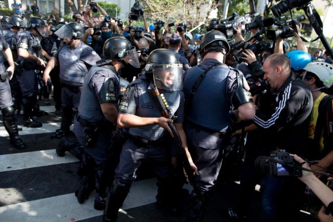 Police shout at journalists covering the detention of a protester on June 12.