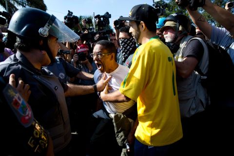 A protester argues with police during the Sao Paulo demonstration on June 12.