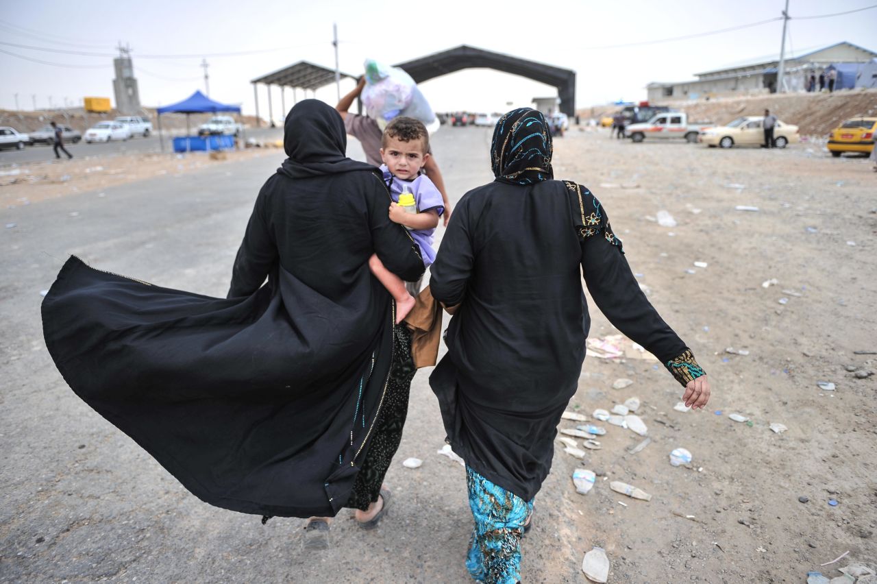 Iraqi civilians from Mosul escape to a refugee camp near Erbil, Iraq, on Thursday, June 12. More than 500,000 people fled in fear after extremist militants overran Mosul, Iraq's second-largest city, on June 10, the International Organization for Migration said.