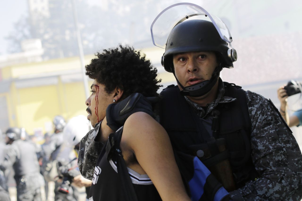 A protester is detained by police on June 12, the opening day of the World Cup. Protesters in Sao Paulo were trying to block part of the main highway that leads to the stadium hosting the first match.
