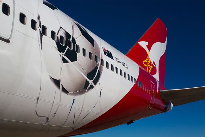 Qantas is "Proudly supporting the Socceroos" with a Boeing 747 decorated with a large football and a pair of golden boots strung around the airline mascot's neck. No jokes about choking, please. 