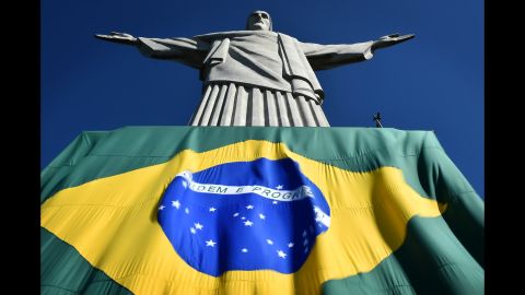 The Brazilian flag is seen at the base of the Christ the Redeemer statue in Rio de Janeiro.