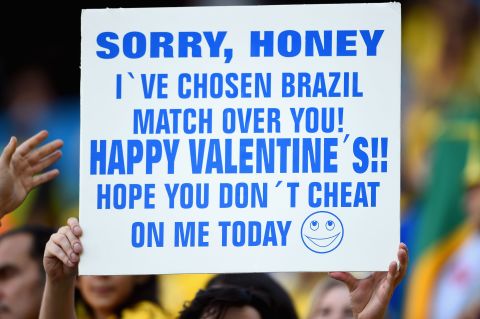 A fan holds up a sign prior to the opening ceremony.