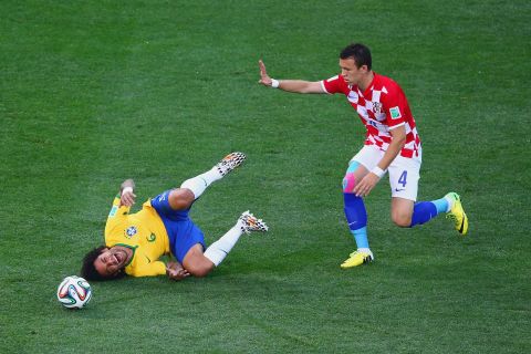 Marcelo falls after a challenge by Croatia's Ivan Perisic.