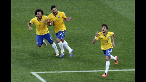Neymar, right, celebrates his first-half goal with teammates Marcelo, left, and Hulk.