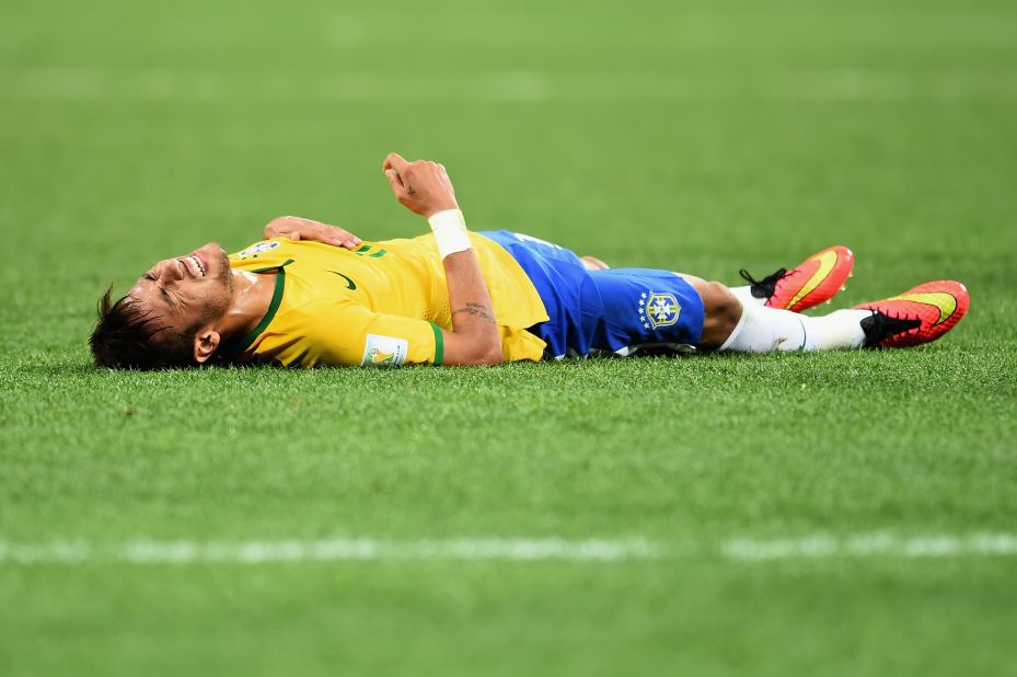 Neymar lies on the field during the first half.