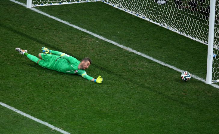 Croatian goalkeeper Stipe Pletikosa dives but fails to stop the ball as Neymar scores his first goal to tie the match at 1-1.