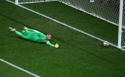 Croatian goalkeeper Stipe Pletikosa dives but fails to stop the ball as Neymar scores his first goal to tie the match at 1-1.