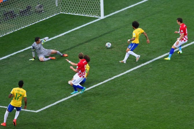 Brazil's Marcelo, second from right, accidentally deflects the ball past his own goalkeeper, Julio Cesar. It was the first goal of the tournament, and it put the host country in an early hole.