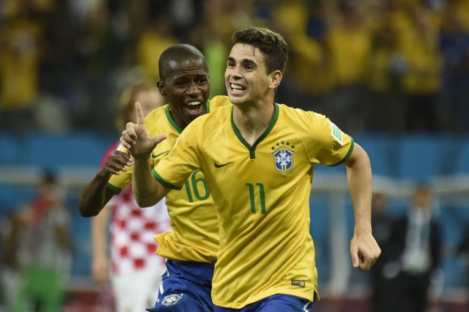 Brazilian midfielder Oscar, right, celebrates after scoring a late goal to give his team a 3-1 win over Croatia in the opening match of the World Cup on Thursday, June 12.