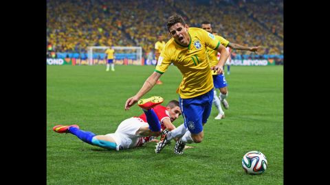 Oscar is tripped up by Croatia's Sime Vrsaljko during the second half.