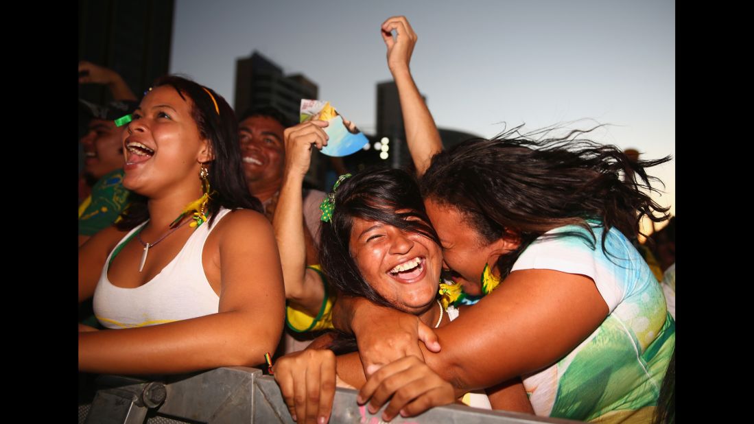 Fans watching the game in Fortaleza, Brazil, celebrate after a Brazil goal.